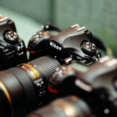 Three nikon cameras side by side.